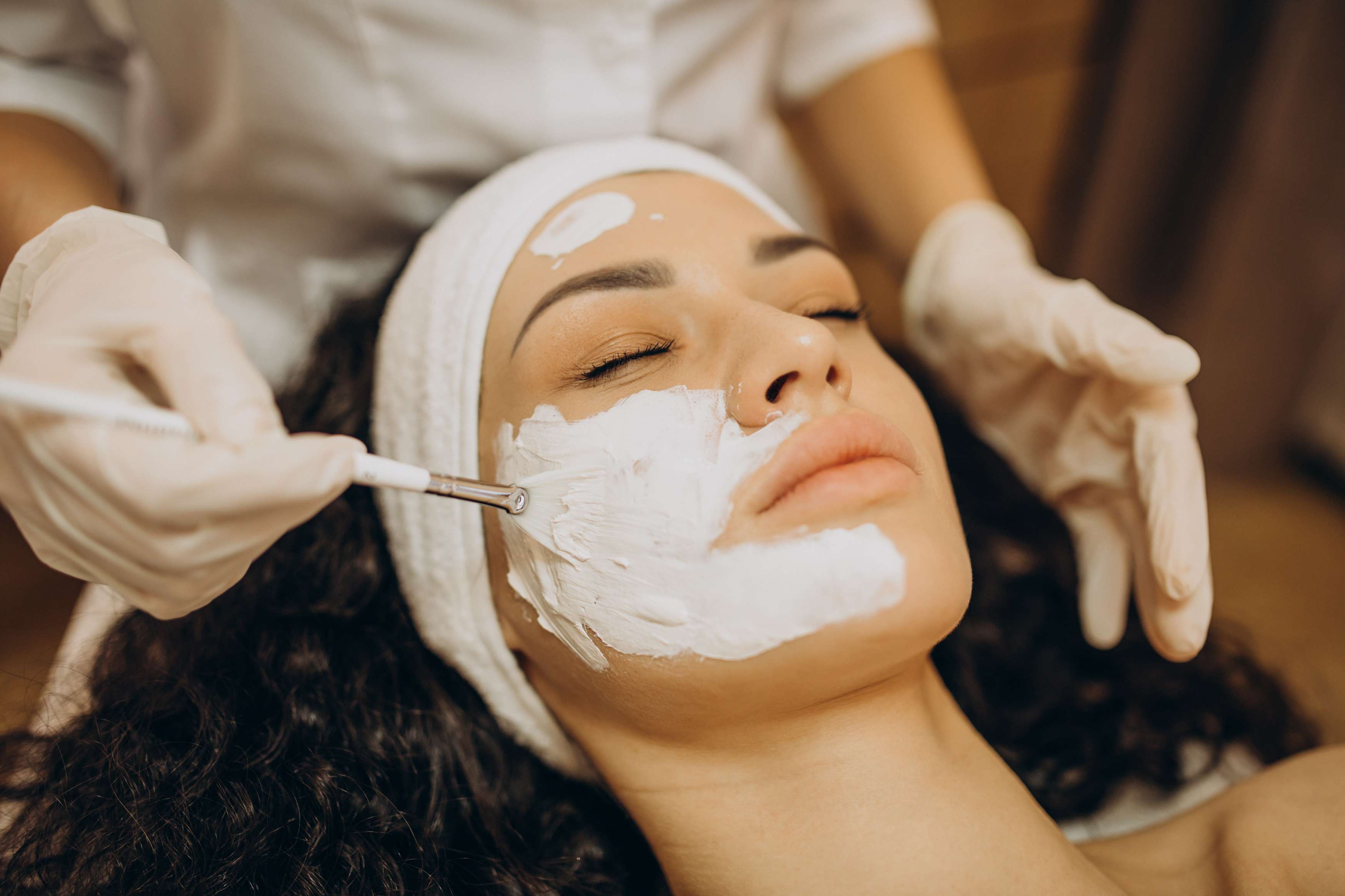 Imagem de produtos de skincare dispostos sobre uma mesa, prontos para serem usados em uma rotina de limpeza de pele profunda em casa.
